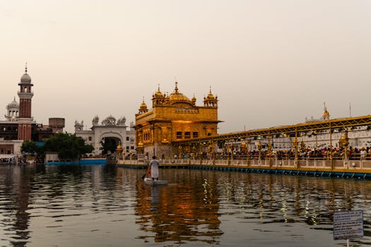 Evening view of Golden Temple in Amritsar, showcasing stunning Sikh architecture and reflections.